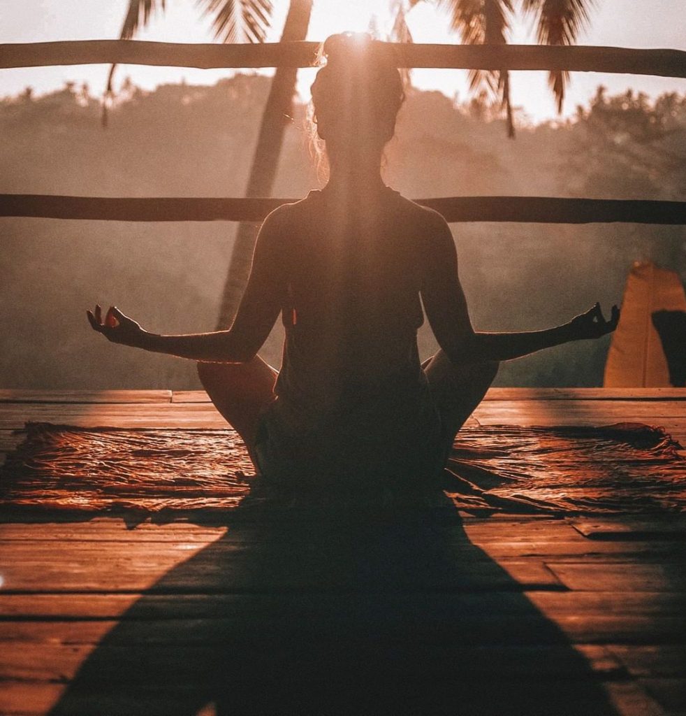 meditating at sunset