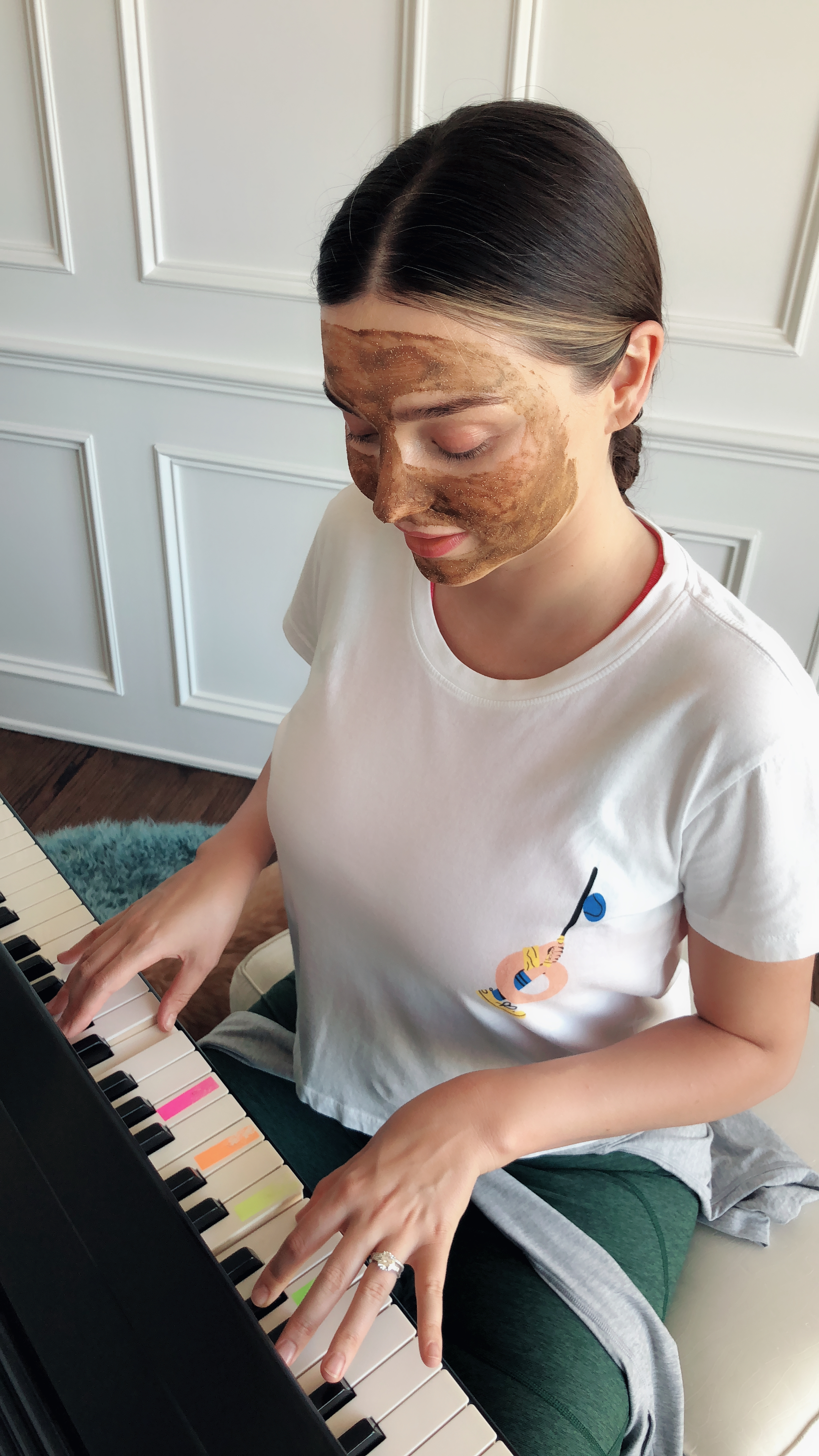 Miranda playing piano while wearing KORA Organics Turmeric Bightening & Exfoliating Mask
