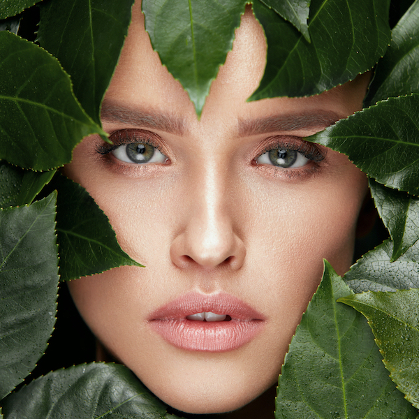 Woman with leaves around face