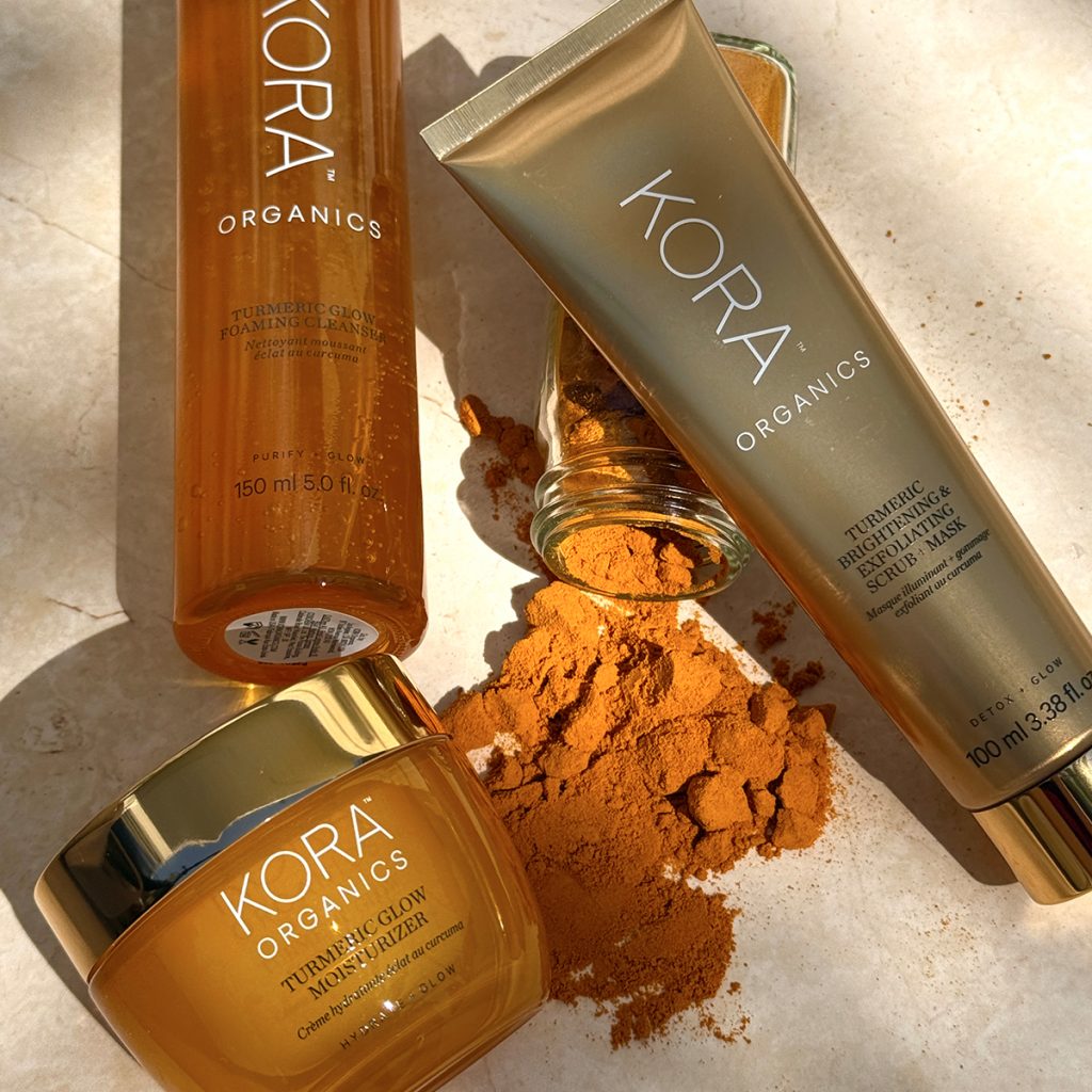 Turmeric skincare products together on tan background