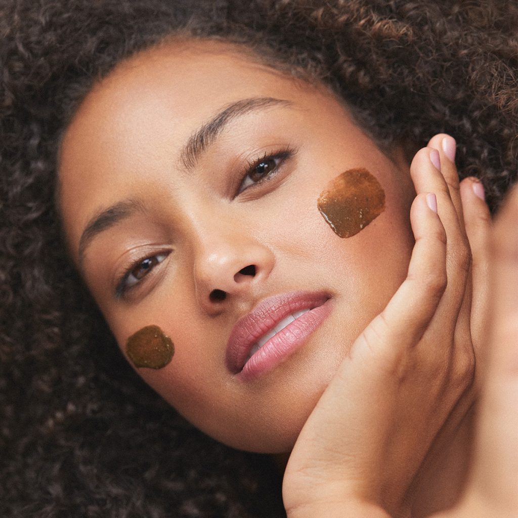 Woman with turmeric mask on cheeks