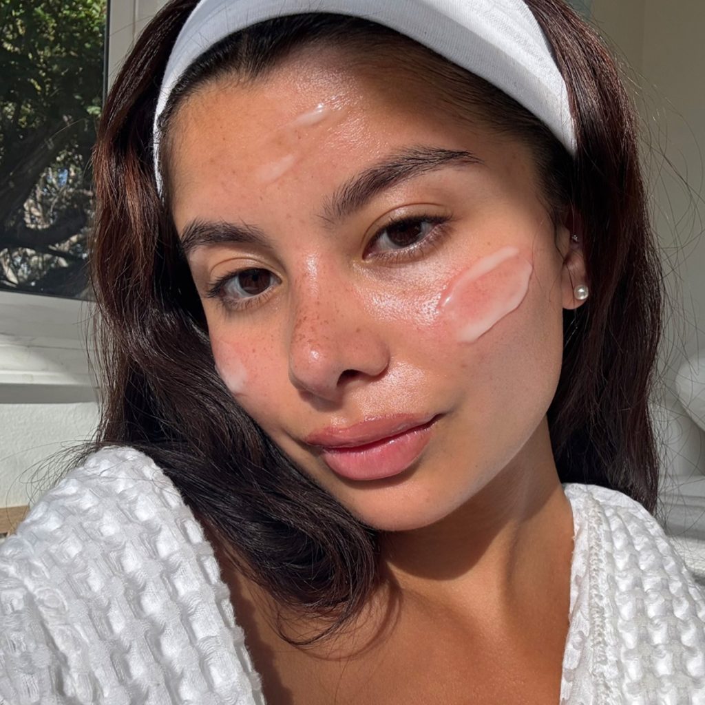 woman with moisturizer on face